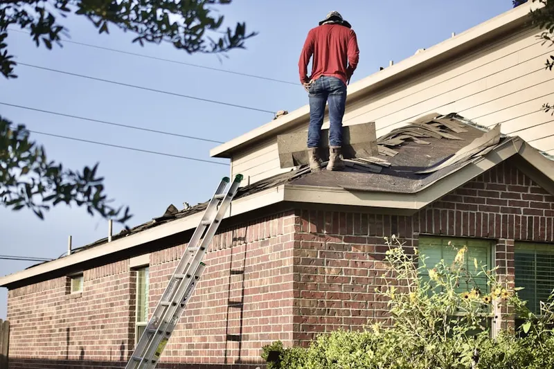 Professional roofer working on a residential roof in Mandeville